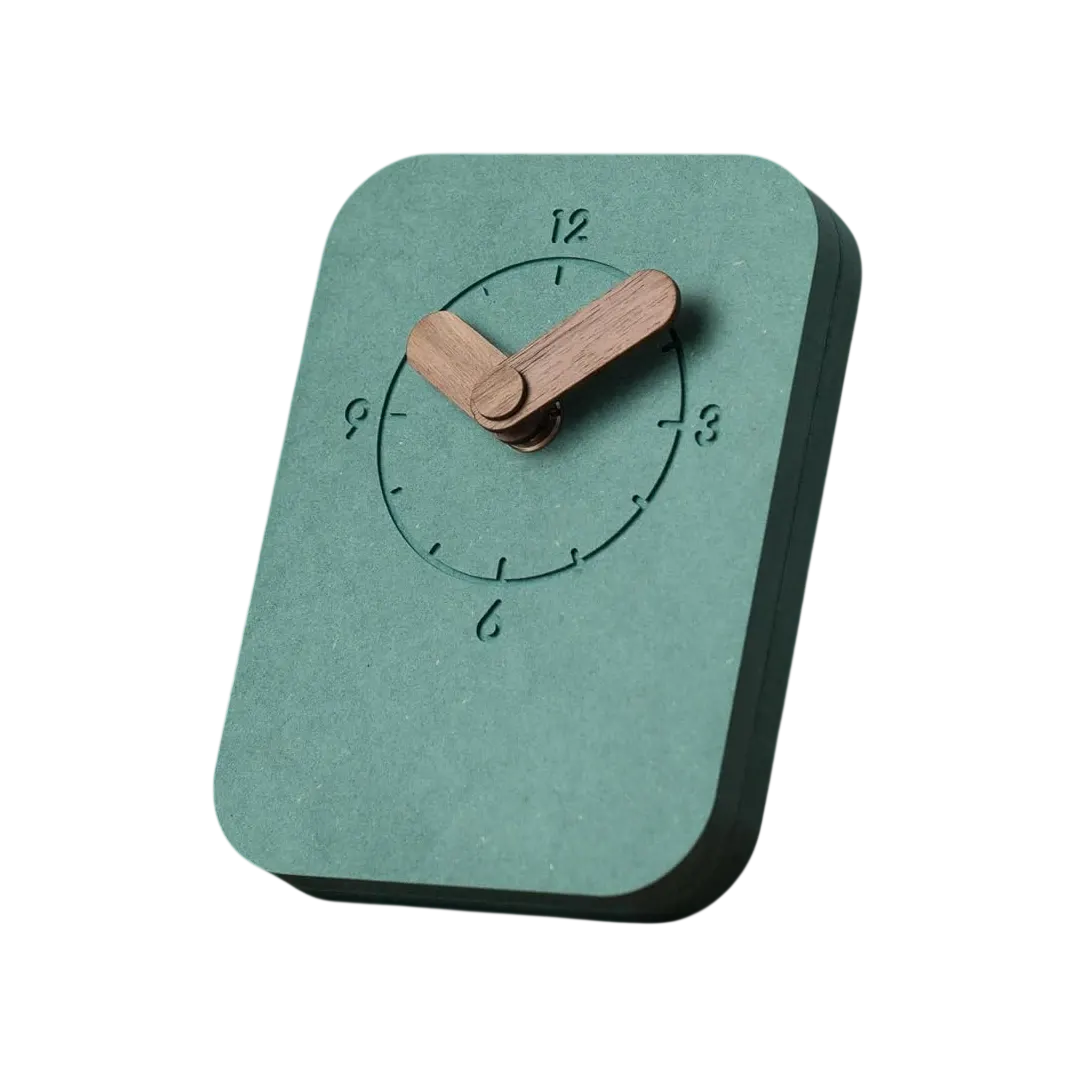A COMMA Aura desk clock with a sage-green face and wooden hands